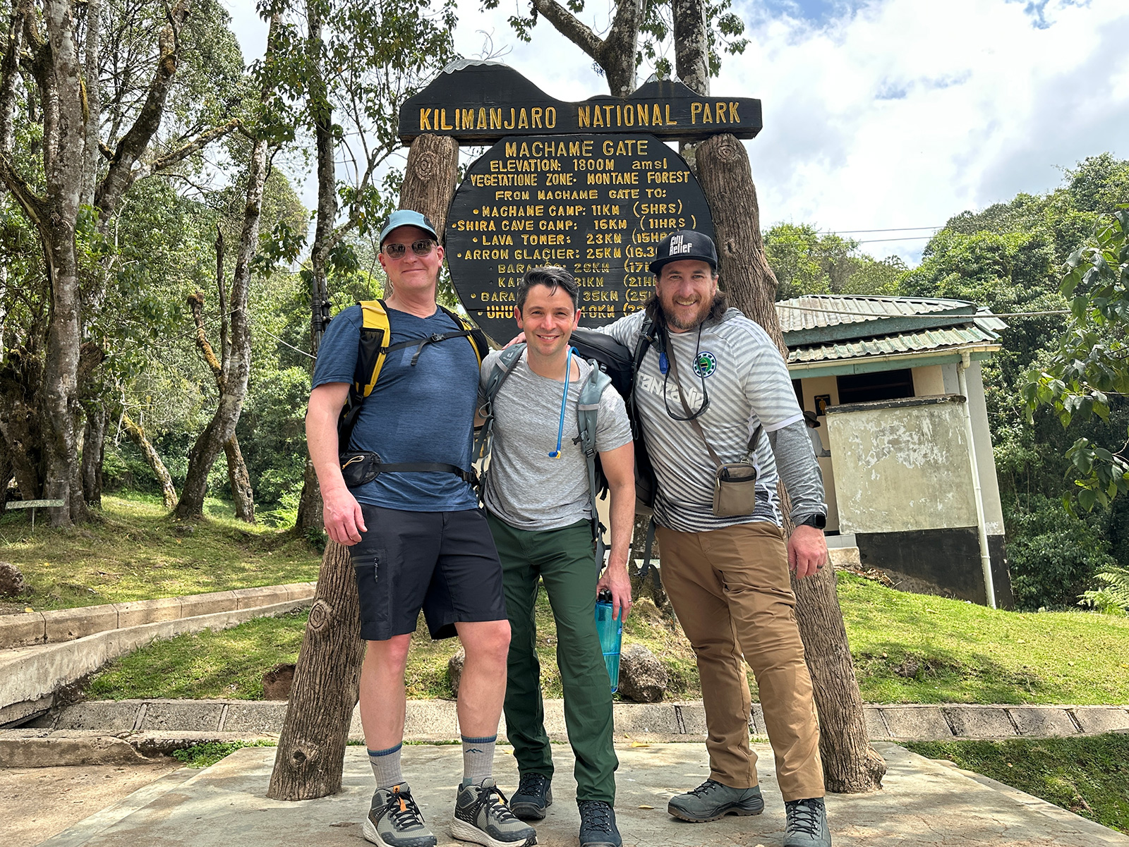 Mark, Dan Sadlier, and Josiah Haken at the entrance to Kilimanjaro National Park 